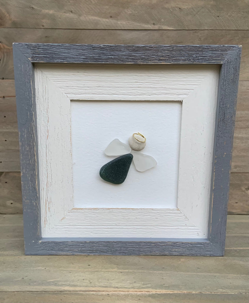 White distressed wood frame with gray trim and sea glass angel. Genuine deep green sea glass body and genuine white sea glass wings